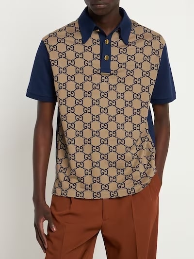 This is a man wearing a Gucci print polo shirt.